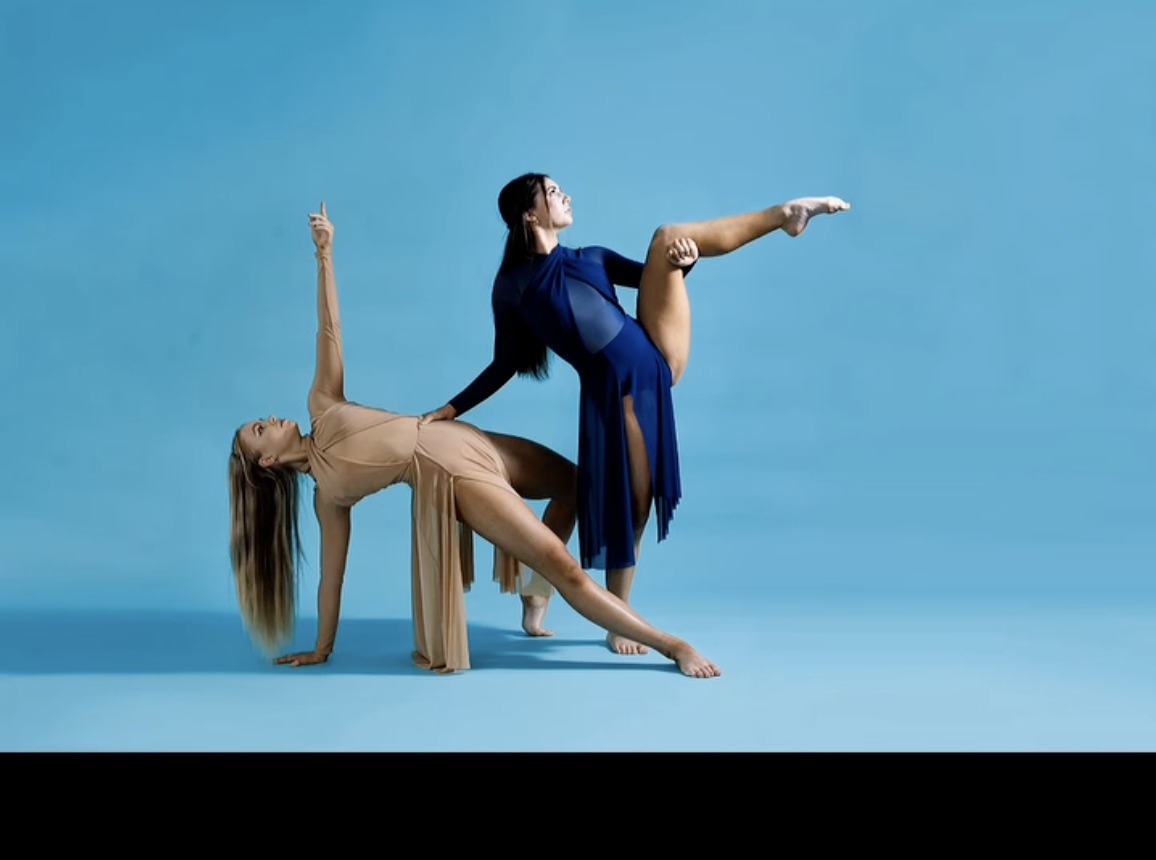 Australian Youth Arts Productions dancers posing against a blue studio backdrop.